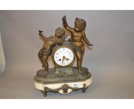 19th Century French gilded spelter and white marble mantel clock, the drum form case surmounted by two figures of Bacchanalia