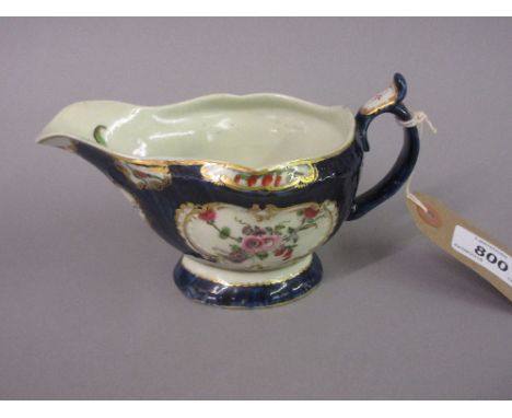 18th Century English sauce boat painted with panels of summer flowers on a blue scale ground (restored) CONDITION REPORT The 