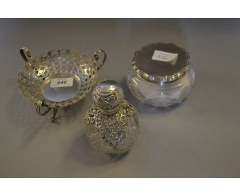 Pierced silver trinket dish (at fault), silver mounted cut glass powder bowl and a silver mounted cut glass perfume bottle (a