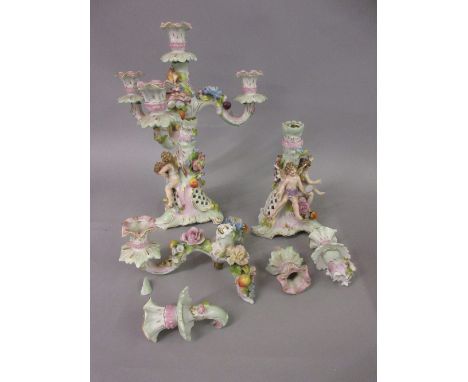 Pair of Continental porcelain candelabra, the columns decorated with figures of cherubs (one at fault)