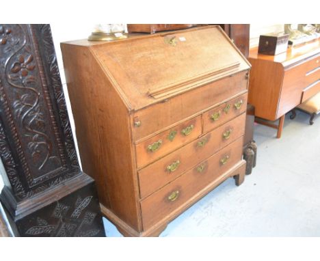 Early 18th Century oak bureau, the fall front enclosing a fitted interior with well above two short and two long drawers with