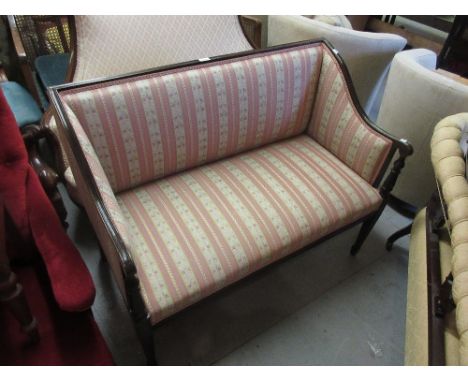 Edwardian mahogany two seater sofa with striped upholstered back and seat, raised on square tapering supports with spade feet