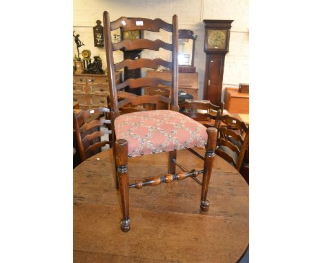 Set of six (four plus two) good quality reproduction oak ladder back dining chairs, each carved with a stylised rose head to 