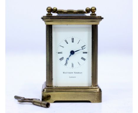 A 20TH CENTURY MATTHEW NORMAN OF LONDON BRASS CASED MINIATURE CARRIAGE CLOCK  in box with key 9.5cm high 