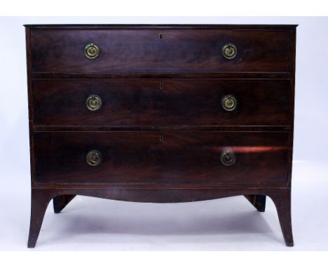 AN ANTIQUE MAHOGANY CHEST OF THREE LONG DRAWERS with brass ring handles and splayed bracket feet, 113cm wide x 57cm deep x 95