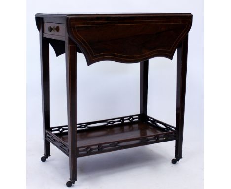 AN EDWARDIAN ROSEWOOD DROP LEAF TABLE with satin wood line inlay, fret carved undertier, square tapering legs and ceramic cas