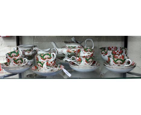 A VICTORIAN HANDPAINTED TEASET in the oriental style with gold, green and gilt decoration consisting of a teapot, teacups, sa