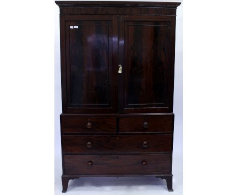 A VICTORIAN FLAME MAHOGANY LINEN PRESS with two cupboard above two short and two long drawers with turned knob handles and sp