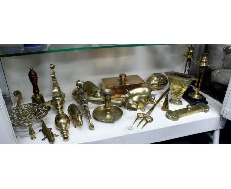 A COLLECTION OF ANTIQUE AND LATER BRASS WARE to include a pair of candlesticks, a chamber stick, fire dogs, brass pigs etc