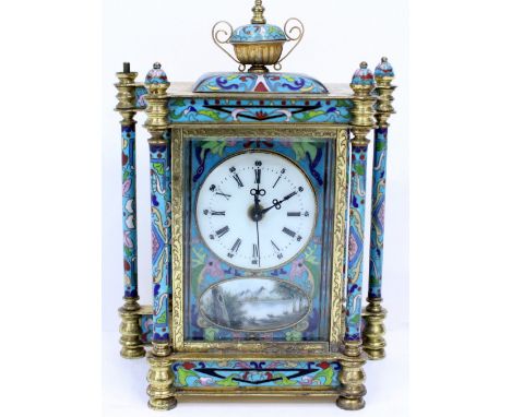 A 20TH CENTURY GILT METAL AND CLOISONNE MANTLE CLOCK with an urn finial and column supports, the enamel dial with Arabic and 