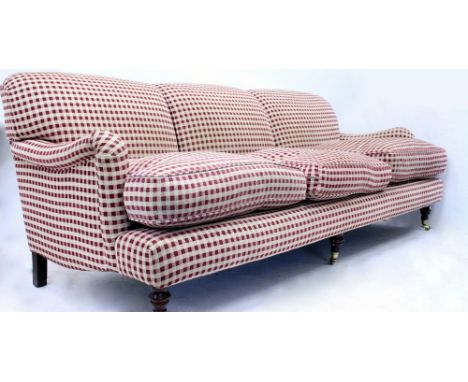 A CONTEMPORARY GINGHAM PATTERN THREE SEATER SOFA standing on turned tapering fore legs terminating in brass casters, 224cm wi