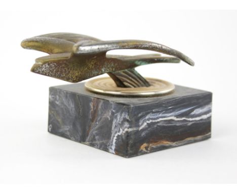 A Desmo Swallow car mascot mounted on marble base. 6cms tall. Please note this lot has the standard Ewbank's standard buyers 