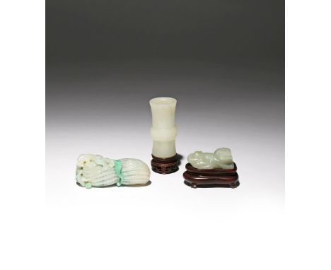 THREE SMALL CHINESE JADE CARVINGS QING DYNASTY One a white jade archaistic gu-shaped vase incised with taotie masks and penda