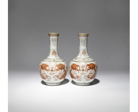 A PAIR OF CHINESE FAMILLE ROSE 'DRAGON' BOTTLE VASES 19TH CENTURY Each decorated with two large iron-red dragons contesting a