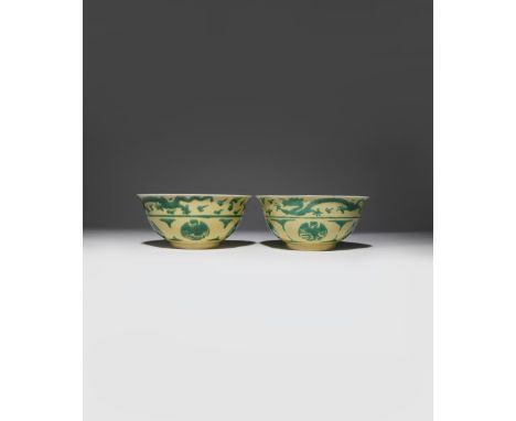 A PAIR OF RARE CHINESE IMPERIAL GREEN AND YELLOW-ENAMELLED 'DRAGON AND PHOENIX' BOWLS SIX CHARACTER KANGXI MARKS AND OF THE P