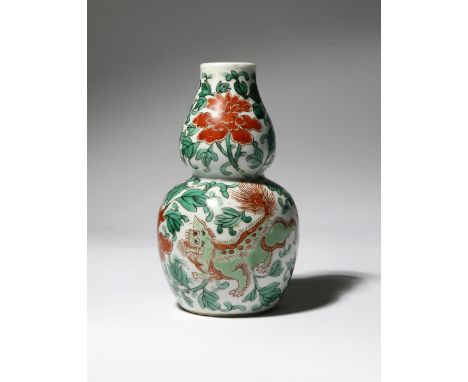 A CHINESE WUCAI GOURD-SHAPED VASE, HULUPING 19TH CENTURY Painted with two lion dogs amidst large flowerheads and scrolling le