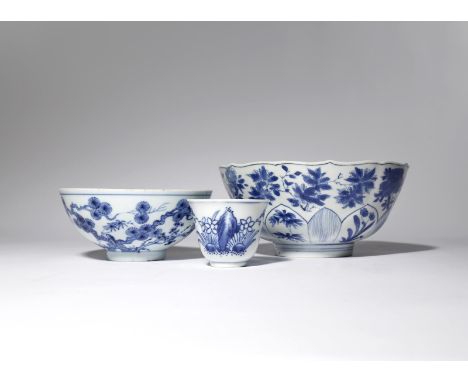 TWO CHINESE BLUE AND WHITE BOWLS AND A WINE CUP QING DYNASTY Comprising: a moulded bowl decorated with various floral sprays,