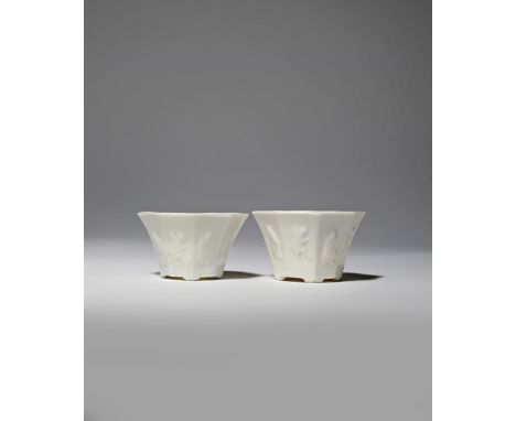 A NEAR PAIR OF CHINESE BLANC DE CHINE 'BAXIAN' WINE CUPS 18TH CENTURY Each with a flared body moulded with the Eight Immortal