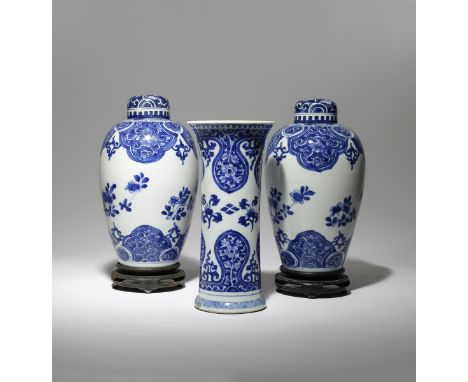 A PAIR OF CHINESE BLUE AND WHITE OVOID VASES AND A BEAKER VASE KANGXI 1662-1722 Decorated with floral and foliate sprays cont