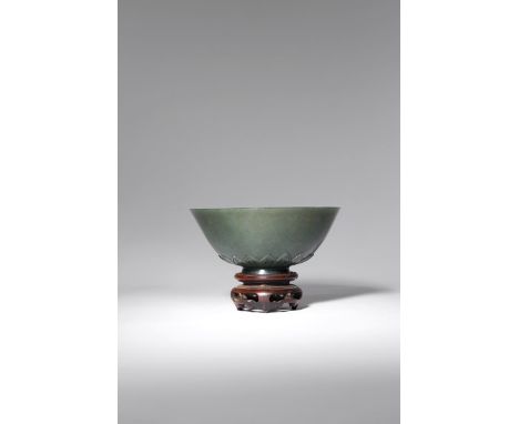 A CHINESE SPINACH-GREEN JADE MUGHAL-STYLE BOWL QING DYNASTY Decorated with a band of upright leaves encircling the tapering f