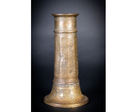 Islamic Art. A Safavid brass torch candlestick Persia, 17th century  . of tapering cylindrical form faceted in the central se