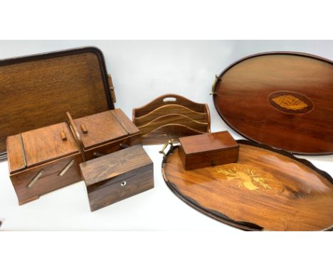  Three wooden trays, to include an oval mahogany example with inlaid shell detail to centre and two brass carry handles, L56.