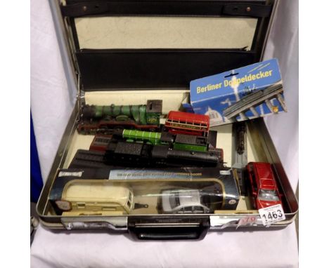 Selection of diecast models in a briefcase, including cars, buses and locomotives. Three curved Ikea mirrors, with wooden sup