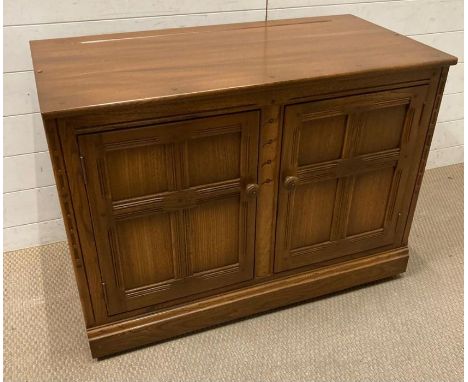 An Ercol two door cupboard with single shelf (71cm x 50cm x 98cm)