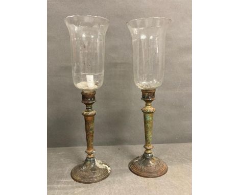 A pair of gothic style candlesticks with amphora glass shades 