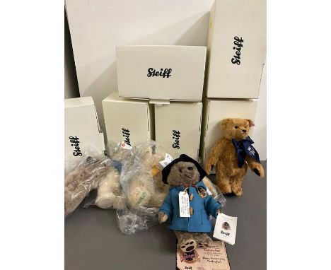 Five Steiff bears with red/white tags including Paddington Bear and one musical bear with yellow tag