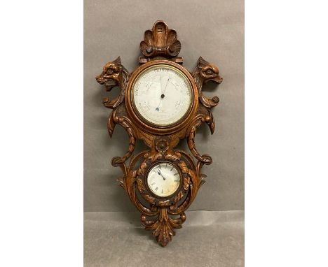 A combination barometer, clock set in carved walnut