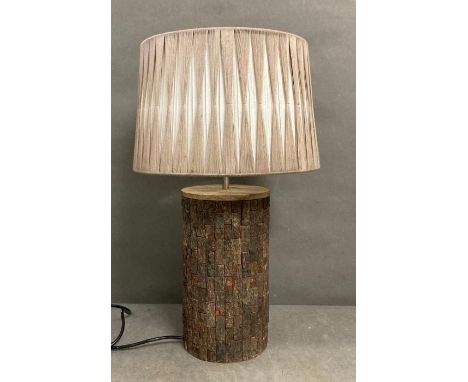 A rustic wooden tree trunk effect table lamp 