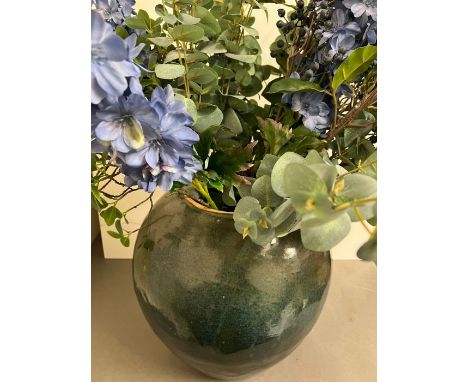 A large glazed terracotta style vase (45cm H) with faux flowers