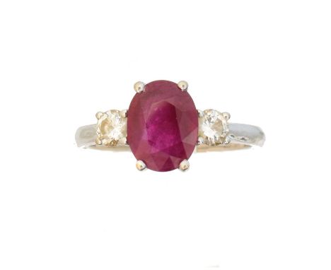 A ruby and diamond three stone ring A ruby and diamond three stone ring, the oval shape ruby with brilliant cut diamond sides