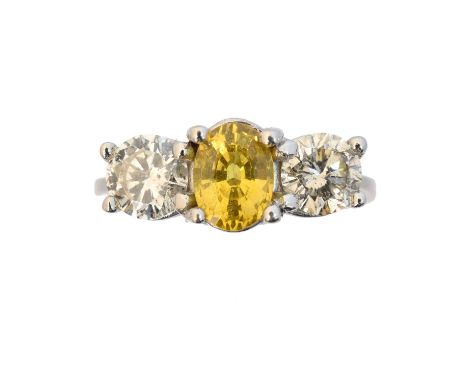 An 18ct gold sapphire and diamond three stone ring, An 18ct gold sapphire and diamond three stone ring, the oval shape yellow