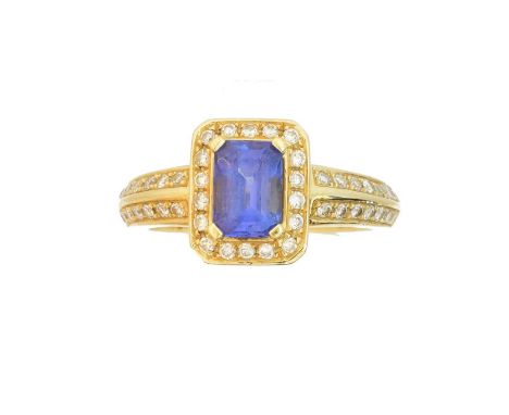 An 18ct gold tanzanite and diamond cluster ring, An 18ct gold tanzanite and diamond cluster ring, the emerald cut tanzanite w