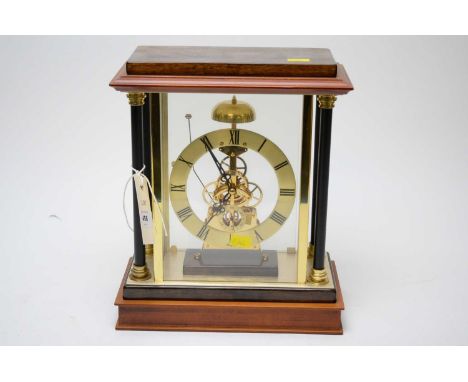 A Woodford gilt metal and stained wood skeleton mantel clock, 29cms high.