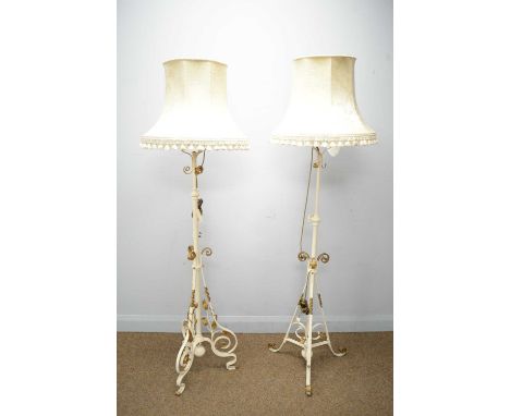 Two ornate wrought iron lamp standards converted from Victorian oil lampstands, with later gold and cream painted detail, eac