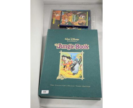 Various movie collectors' items, including: Walt Disney Classics The Jungle Book: The Collector's Deluxe Video Edition; The D