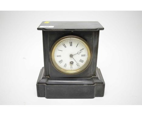A Victorian black slate mantel clock, of small proportions, the circular white dial with black roman numerals, architectural 