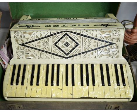 A Pietro Italia piano accordion, with carrying case and strap.