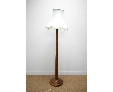 Substantial fluted mahogany lamp standard with stepped base and tasselled shade, 191cms high.