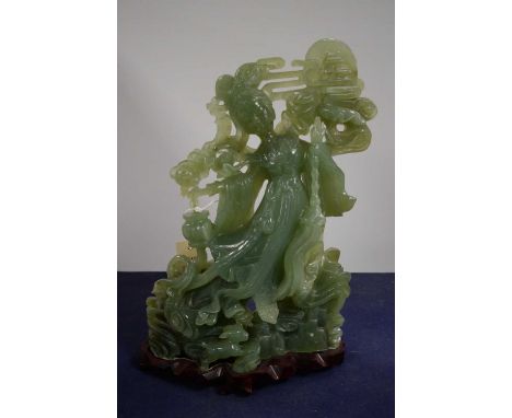 A Chinese carved jade figure, modelled as a lady, on a carved hardwood base, with box. 