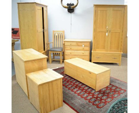 Modern bedroom furniture, comprising: a pair of modern wardrobes, each with a pair of panelled doors enclosing hanging space,