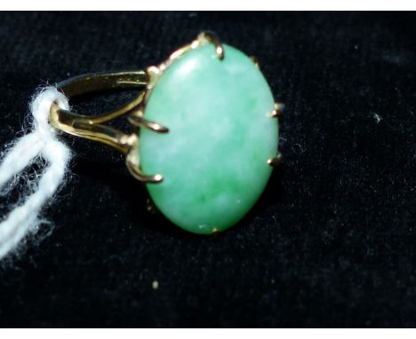 A jade set dress ring stamped '18CT', 2.6 gm gross