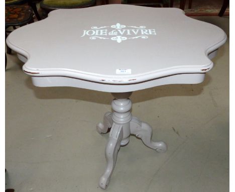 A painted coffee table on tripod base