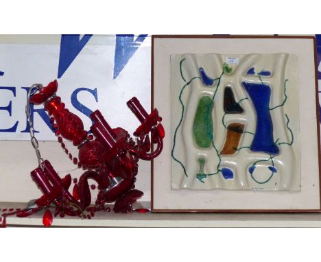 A ruby glass 5 branch chandelier; a modernist ceramic wall sculpture signed 'Hart'