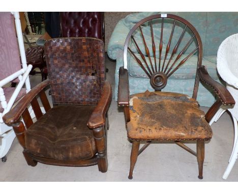 A 1930's stick back armchair with cross-stretcher, leather seat and arms (requires restoration); a 1930's oak low seat armcha