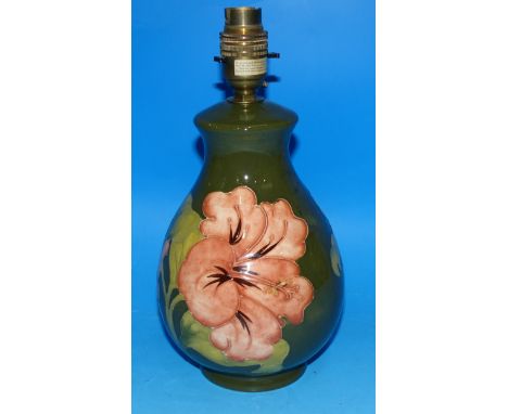 A Moorcroft pottery table lamp with amaryllis on green ground, 10" overall