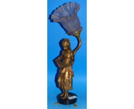 A gilt table lamp in the form of a figure of a girl reading